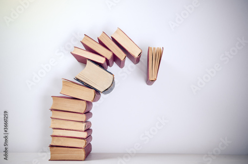 Falling books on simple background