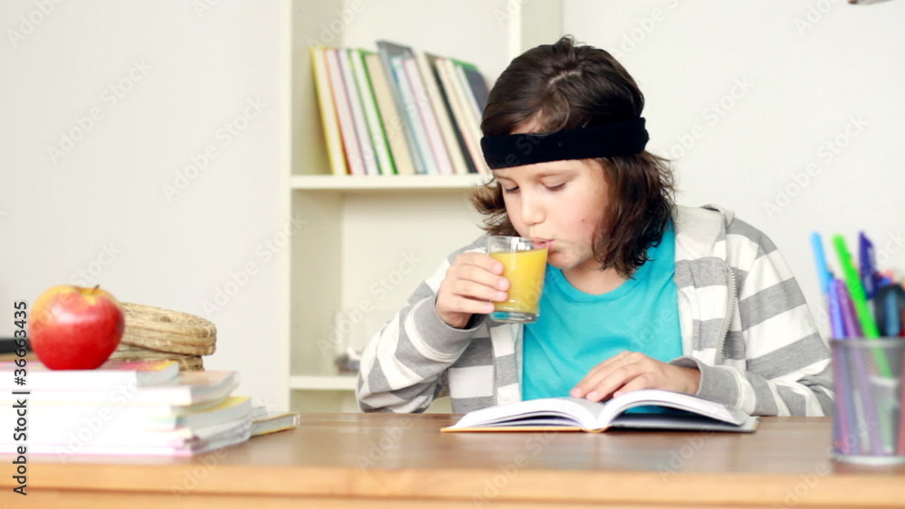 Young teenager reading book by the table, steadicam shot Young teenager reading book by the table, steadicam shot