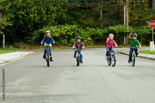 group of kids riding bikes with helmets on