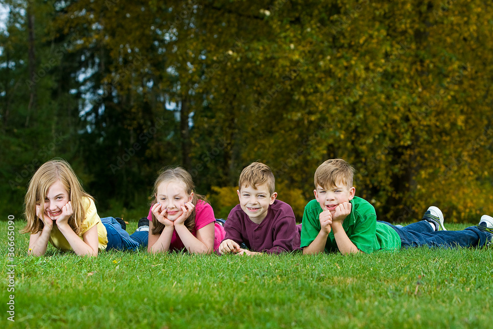 Group of kids laying down in grass