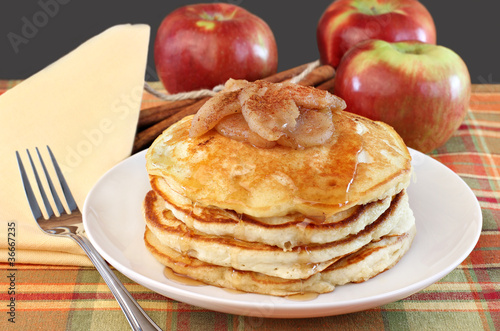 Stacked pancakes with baked apples topping.