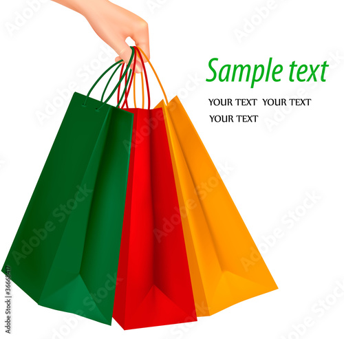 Female hand holding colorful shopping bags. Vector illustration.