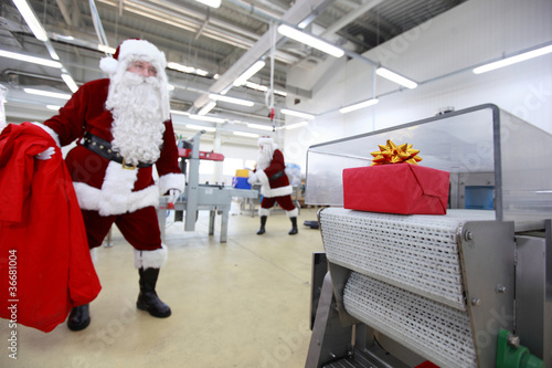 santa claus waiting for present in factory
