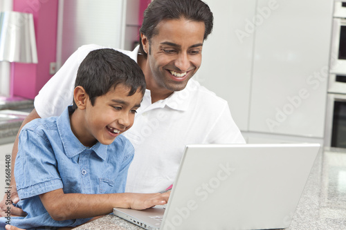 Asian Indian Father & Son Using Laptop Computer at Home