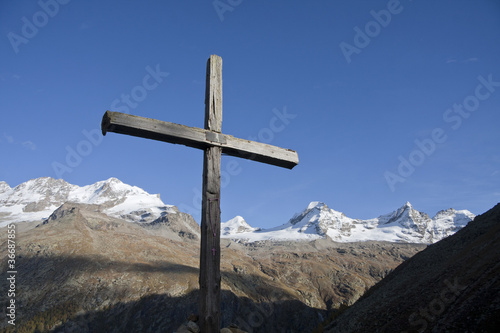 Alpine landscape with wooden cross