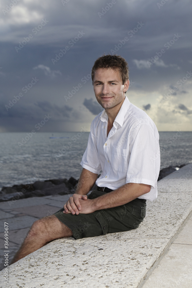 Man posing by the sea