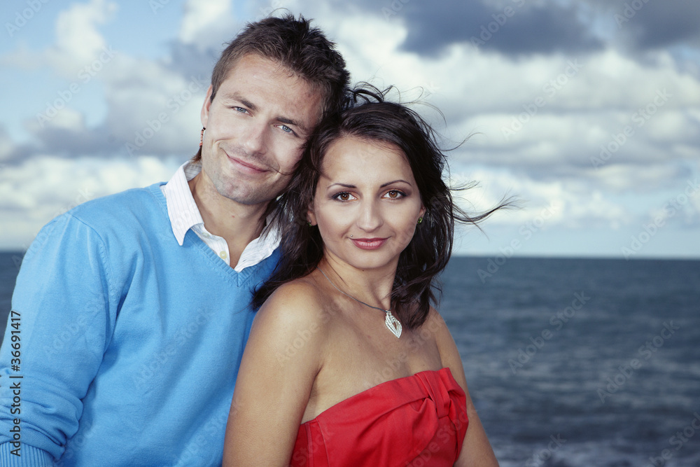 Couple posing by the sea