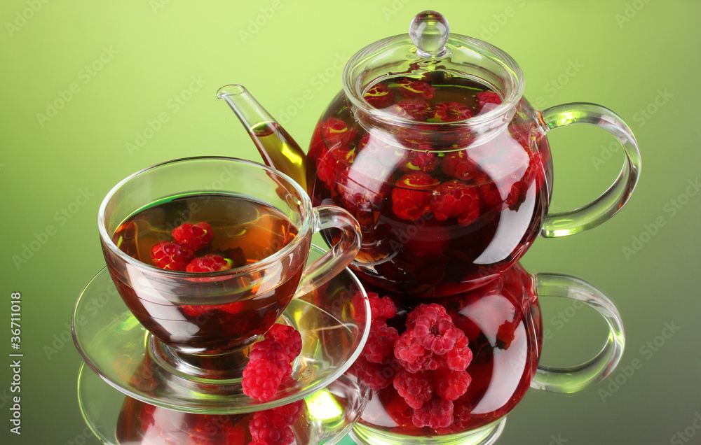 Black fruit raspberry tea in glass teapot and cup Black fruit raspberry tea in glass teapot and cup