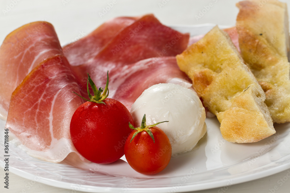 Ham tomatoes mozzarella and focaccia pizza Ham tomatoes mozzarella and focaccia pizza