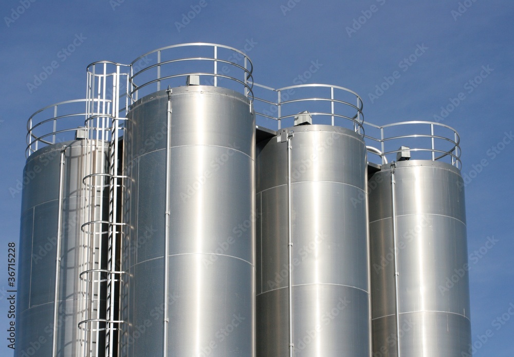 View of an industrial plant with large aluminum tanks View of an industrial plant with large aluminum tanks