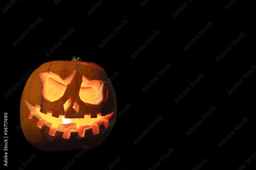 Fototapeta premium Spooky Halloween pumpkin on black background