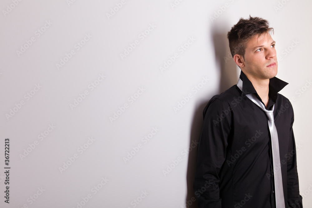 Picture of a handsome casually man leaning against the wall Picture of a handsome casually man leaning against the wall