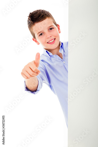 Happy boy showing thumbs up look out from white blank banner