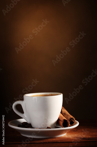 cup with coffee  cinnamon and coffee beans