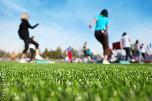 mass fitness at stadium at sunny autumn day
