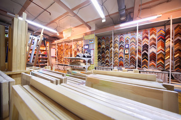 on shelves many canvases on stretchers for artists