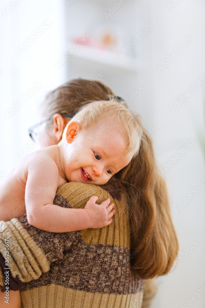 Little cute baby hanging mama