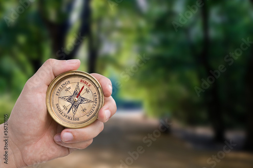 Male Hand Holding Christian Compass