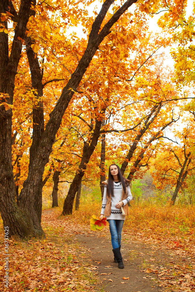 woman walking in autmn park woman walking in autmn park