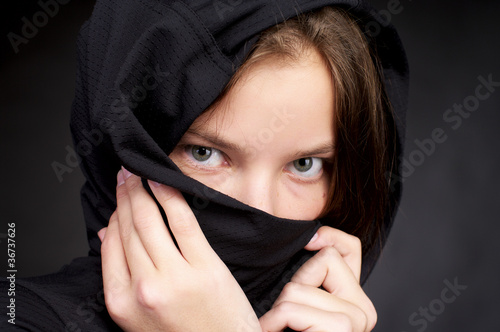Foto Beautiful woman hiding her face by headscarf