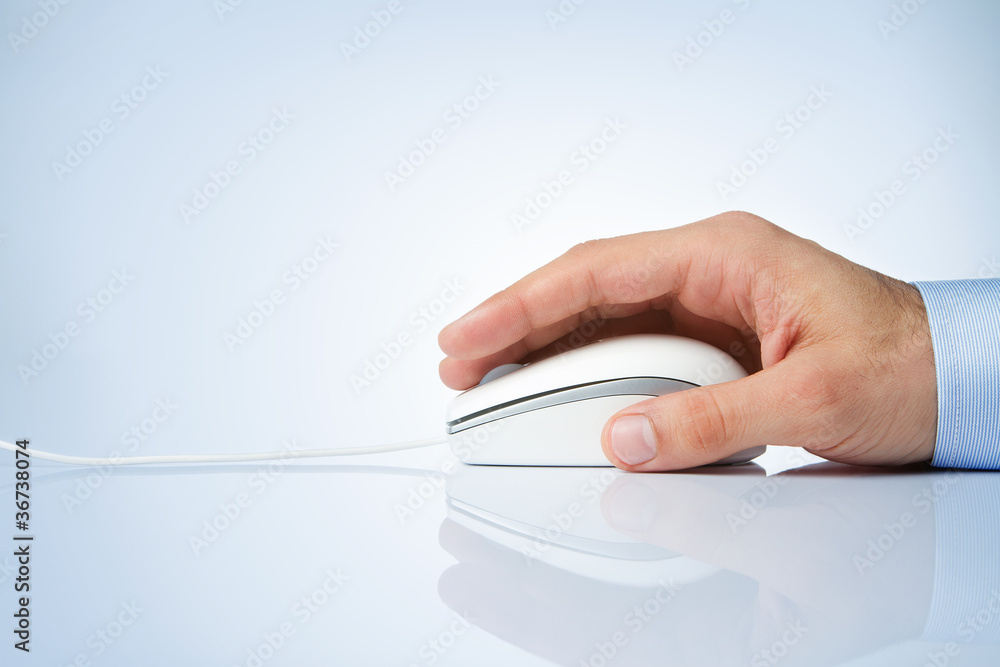 Male hand holding computer mouse with copy space Male hand holding computer mouse with copy space