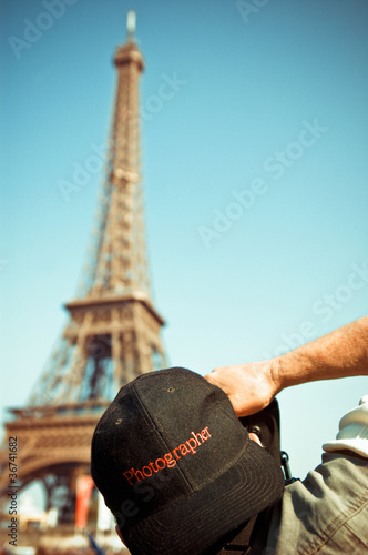 Professional photographer taking picture of eiffel tower