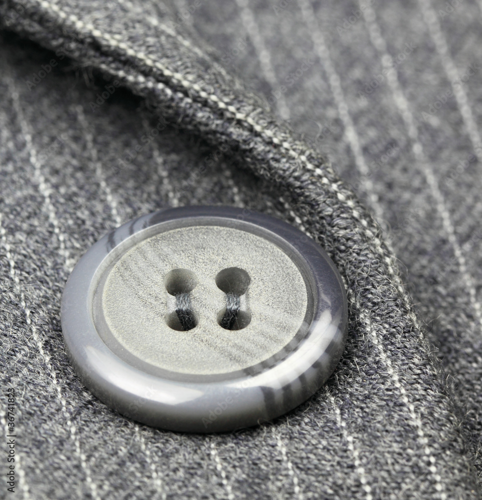Button on a gray suit Button on a gray suit