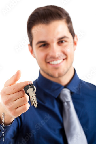 Young businessman holding a key