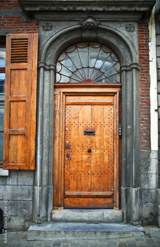 Old wooden door in the town of Mons. Belgium.