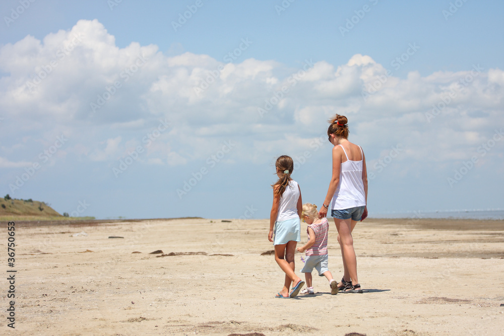 mother with her children on a beach.