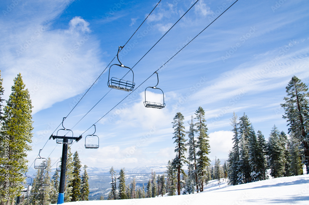 Chair lifts against the blue sky