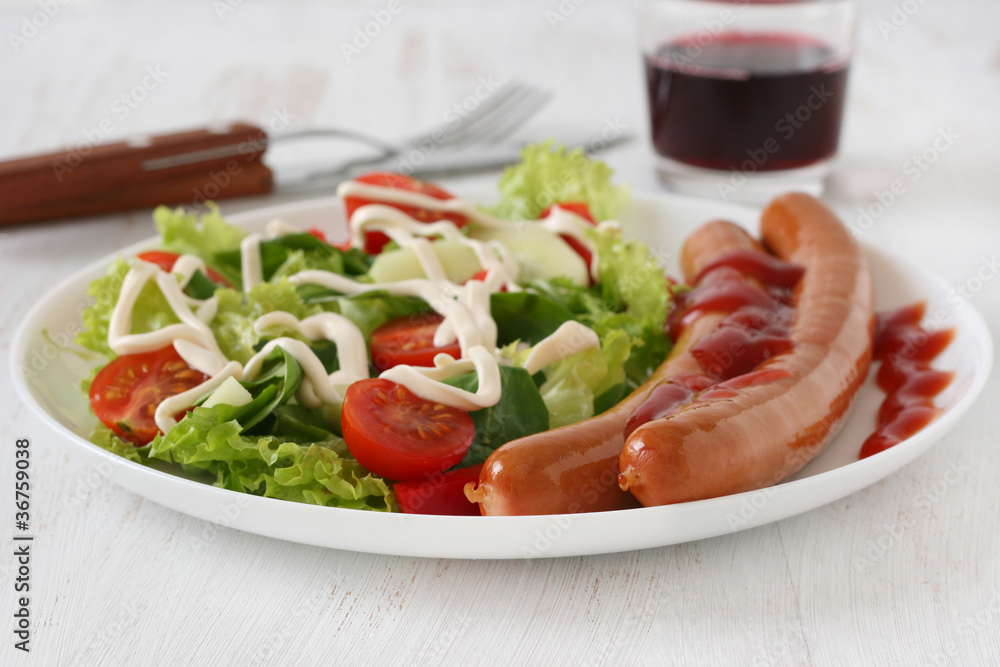 sausages with salad on white plate