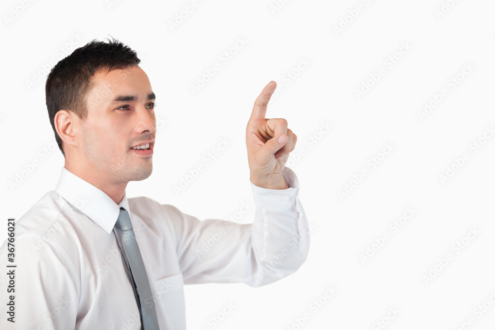 Businessman pointing at invisible screen Businessman pointing at invisible screen