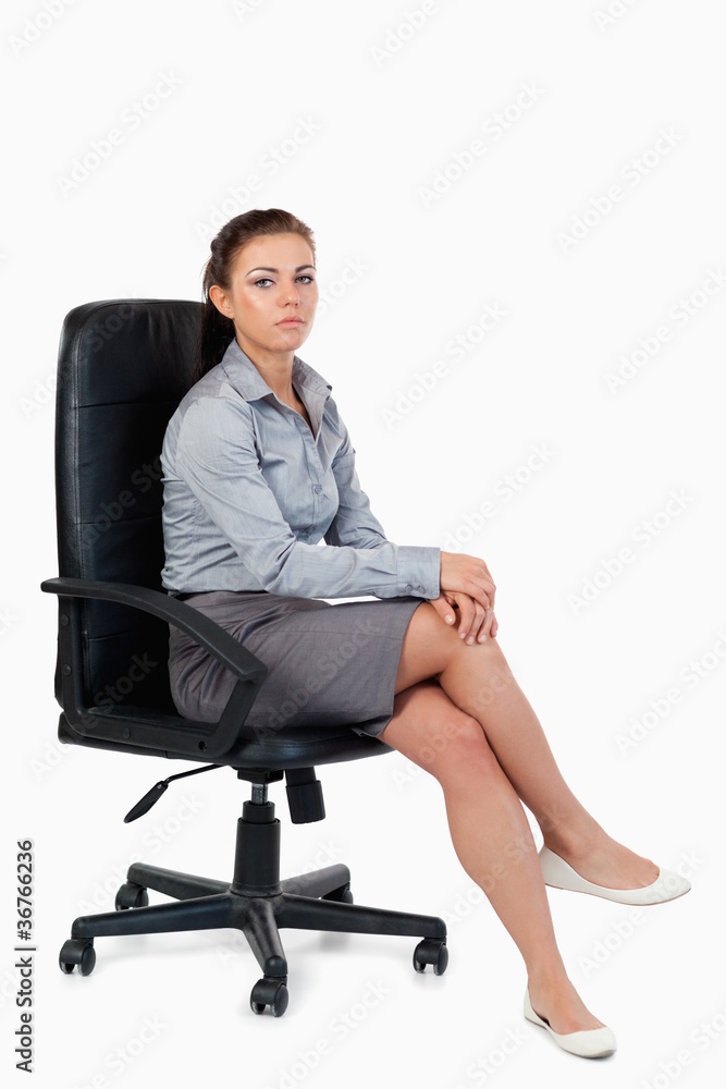 Portrait of a businesswoman sitting on an armchair Portrait of a businesswoman sitting on an armchair