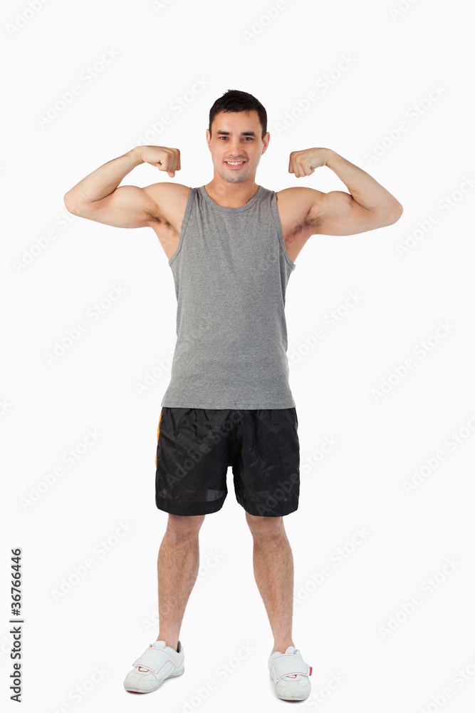 Young man presenting his muscles Young man presenting his muscles