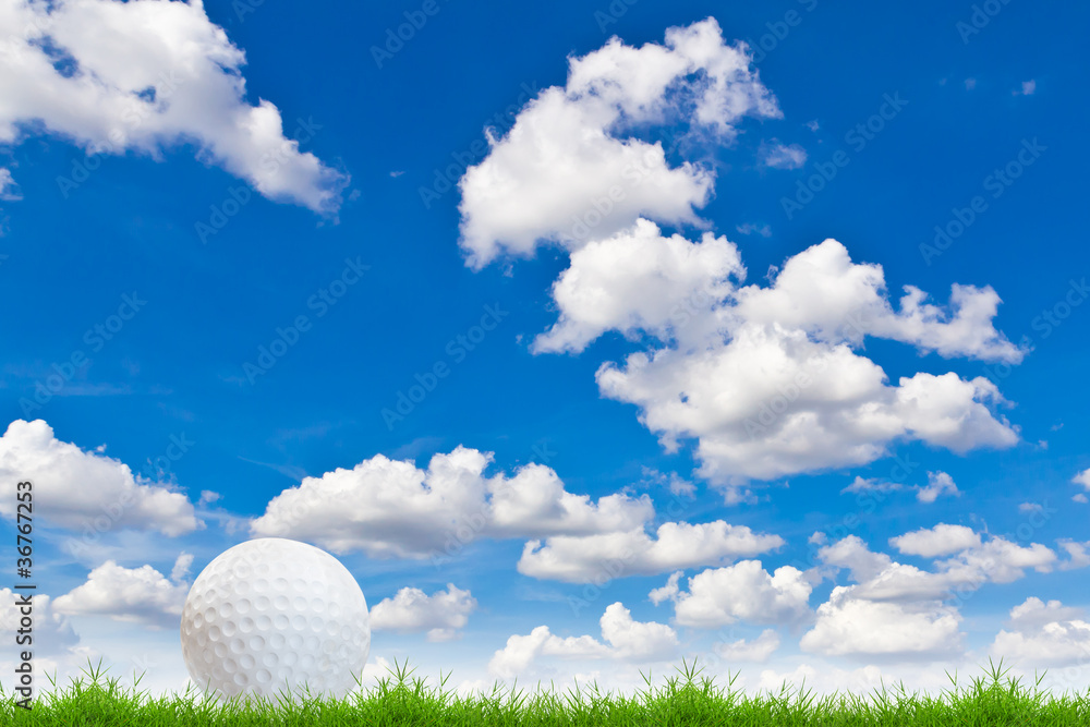 golf ball on green grass against blue sky golf ball on green grass against blue sky