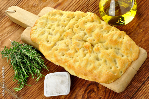 Focaccia with rosemary, coarse salt and olive oil photo