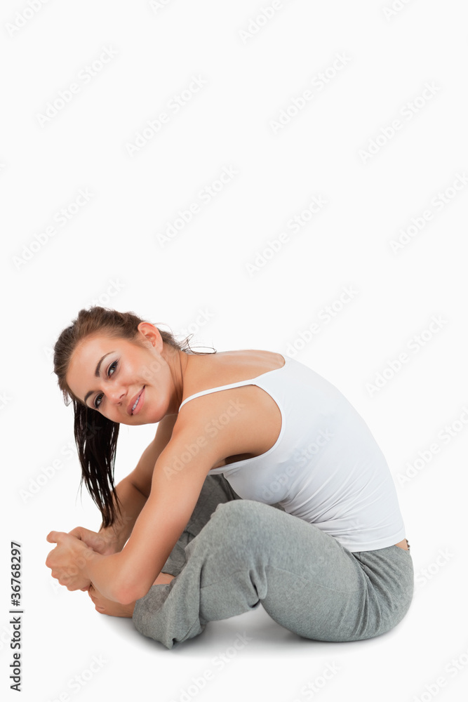 Portrait of a fit woman stretching her legs