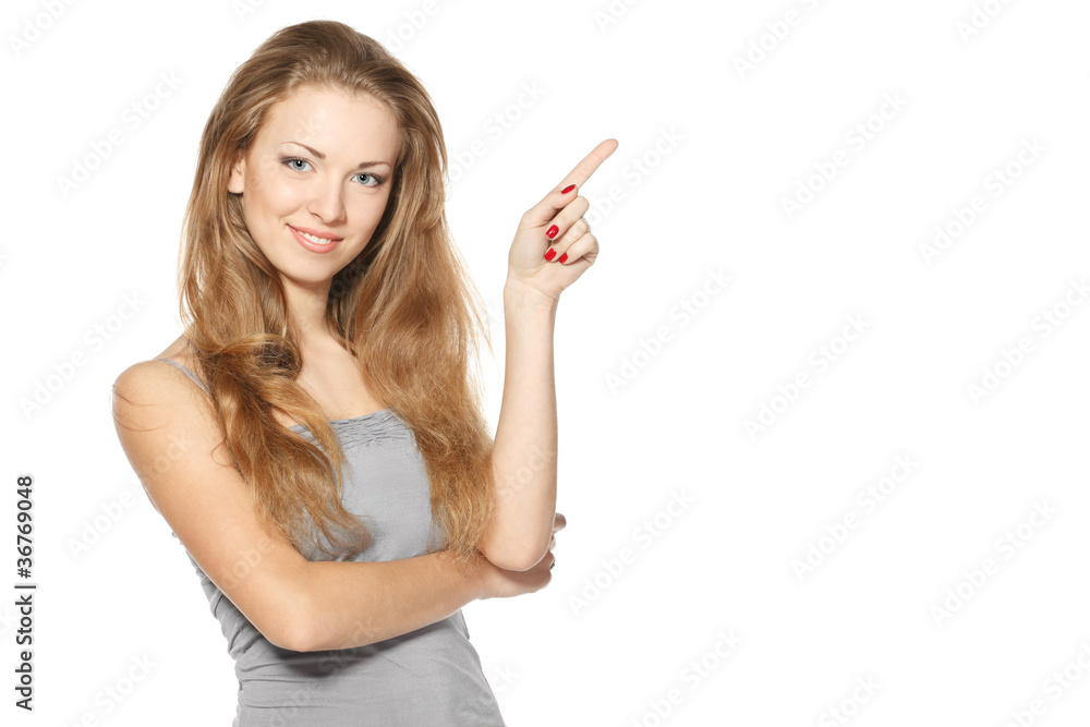Beautiful blond female pointing at copy space Beautiful blond female pointing at copy space
