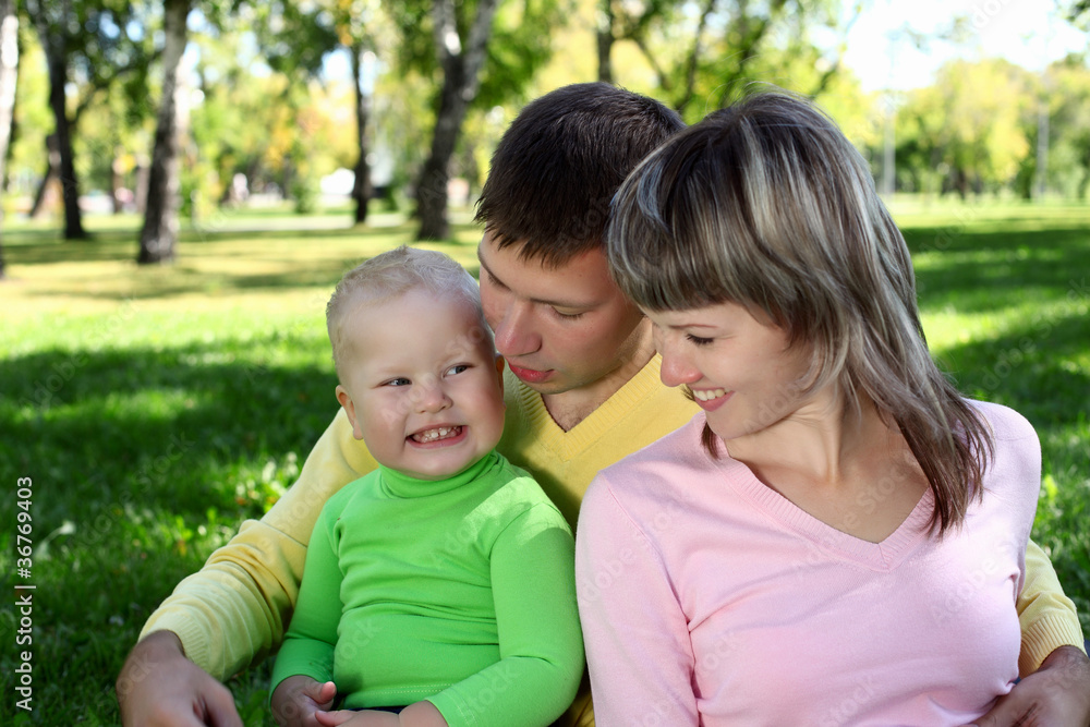 Young family with a child in summer park Young family with a child in summer park
