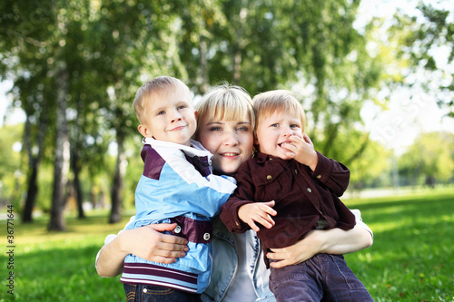 Young mother with her son in summer park