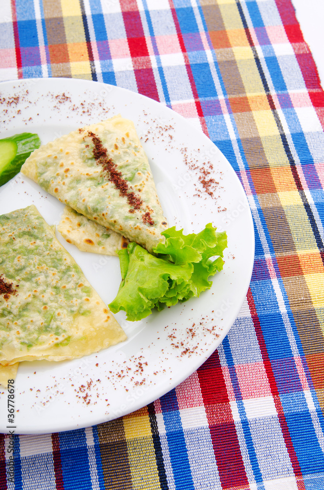 Herb stuffed pancaces in the plate Herb stuffed pancaces in the plate