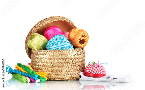 bright threads for needlework and fabric in a wicker basket
