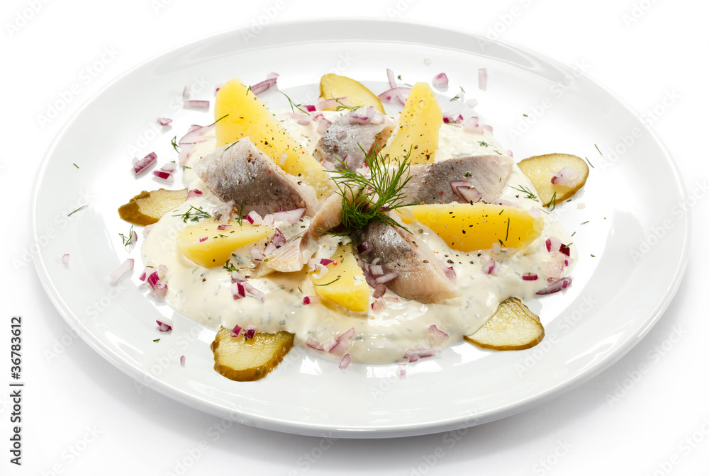 Marinated herring fillets with cream and vegetables