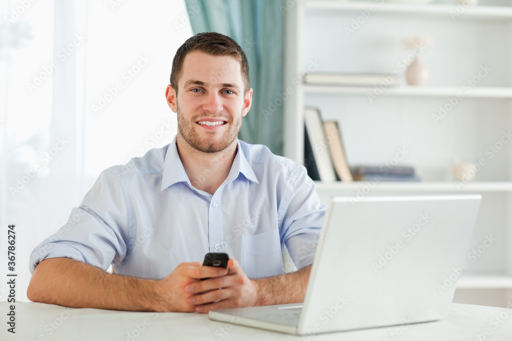 Young businessman typing text message in his homeoffice Young businessman typing text message in his homeoffice