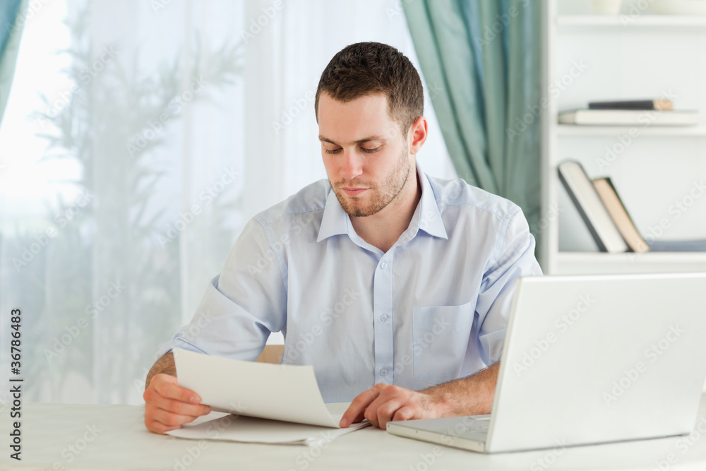 Businessman reading a letter in his homeoffice Businessman reading a letter in his homeoffice