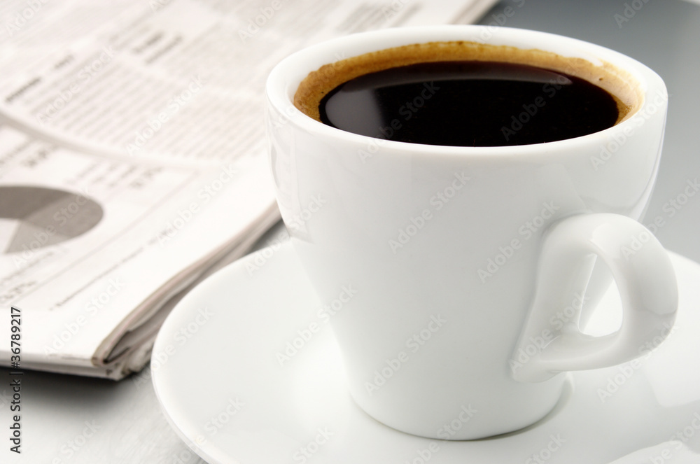cup of coffee and a newspaper cup of coffee and a newspaper