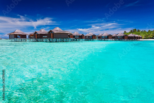 Overwater bungallows in blue lagoon © Martin Valigursky