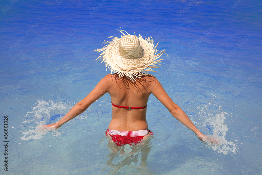 Naklejka premium Happy Woman in azure swimming pool