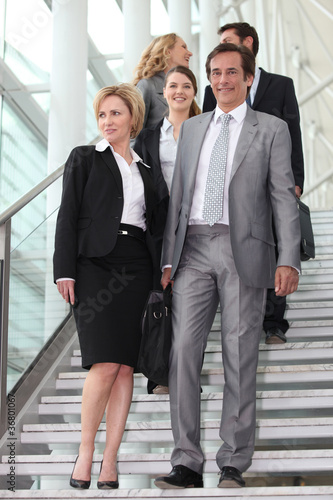 Business people walking down steps